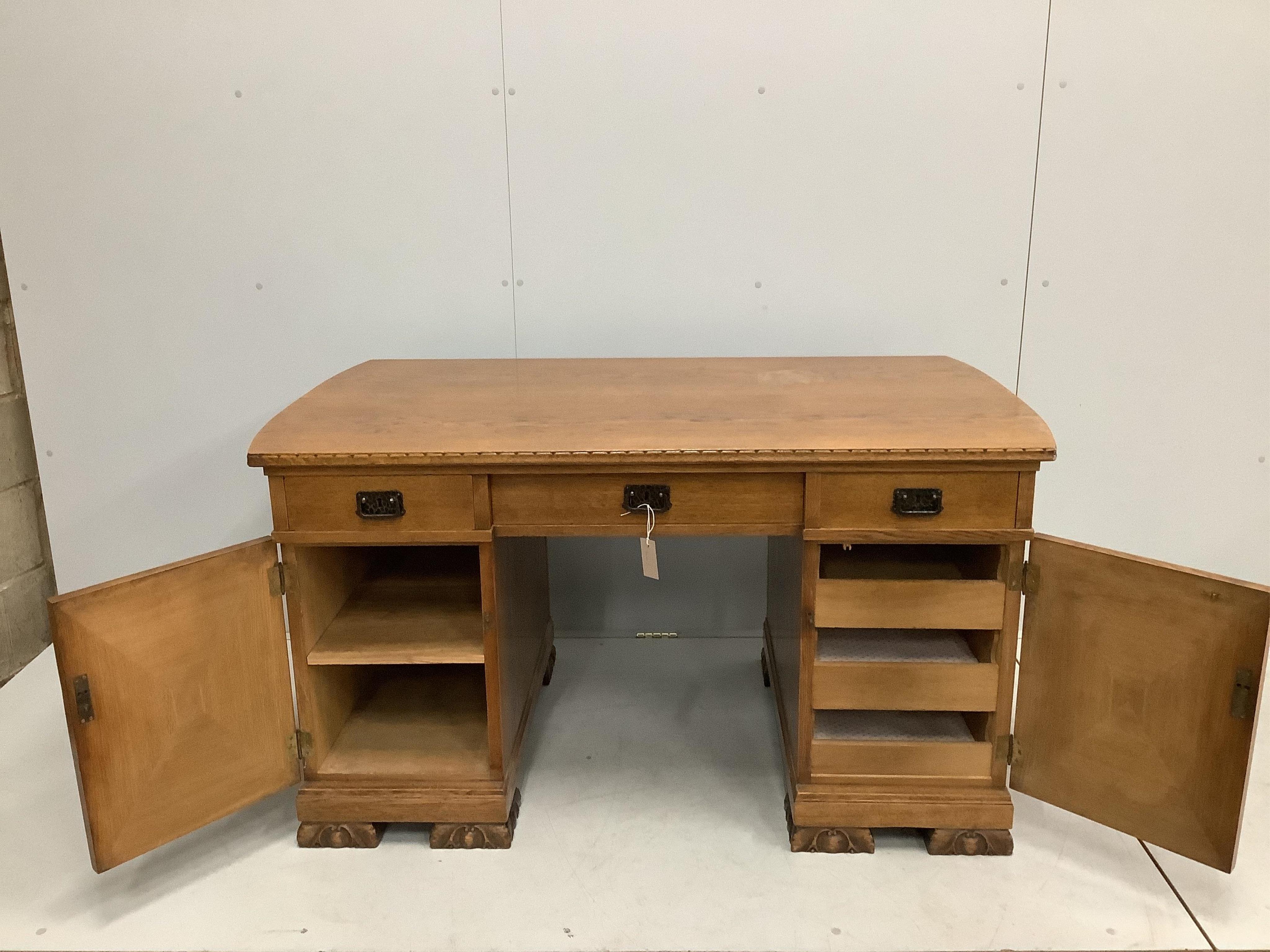 An early 20th century French oak pedestal desk, width 139cm, depth 79cm, height 76cm. Condition - fair